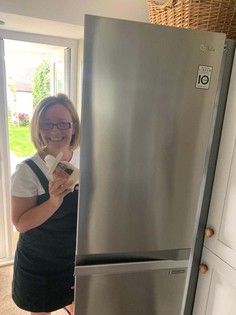 jas by the fridge holding cheese
