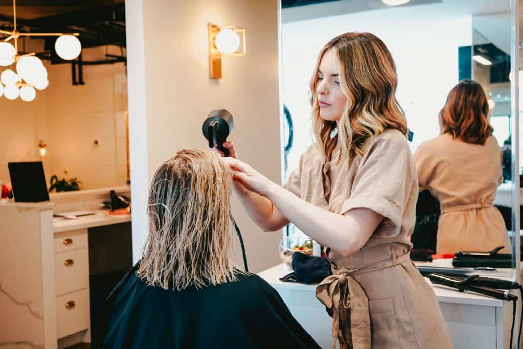 woman blowdrying customers hair