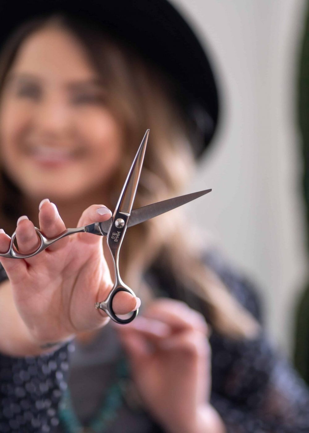 hairdresser holding scissors